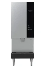 A commercial ice dispenser with a stainless steel exterior, control buttons, a dispensing area, and four metal legs.
