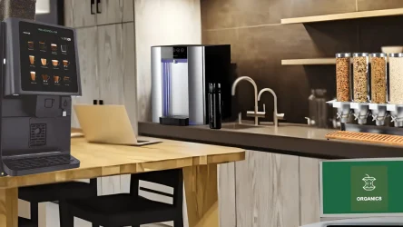 Modern kitchen with a coffee machine, water dispenser, cereal dispensers, a laptop on the table, and ORGANOS branding on a screen.